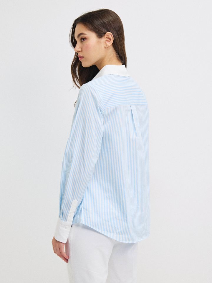 חולצה פסים שילוב מנגטים בצבע תכלת